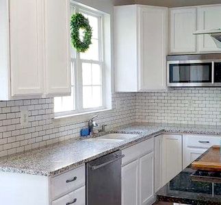 Kitchen with white cabinets.